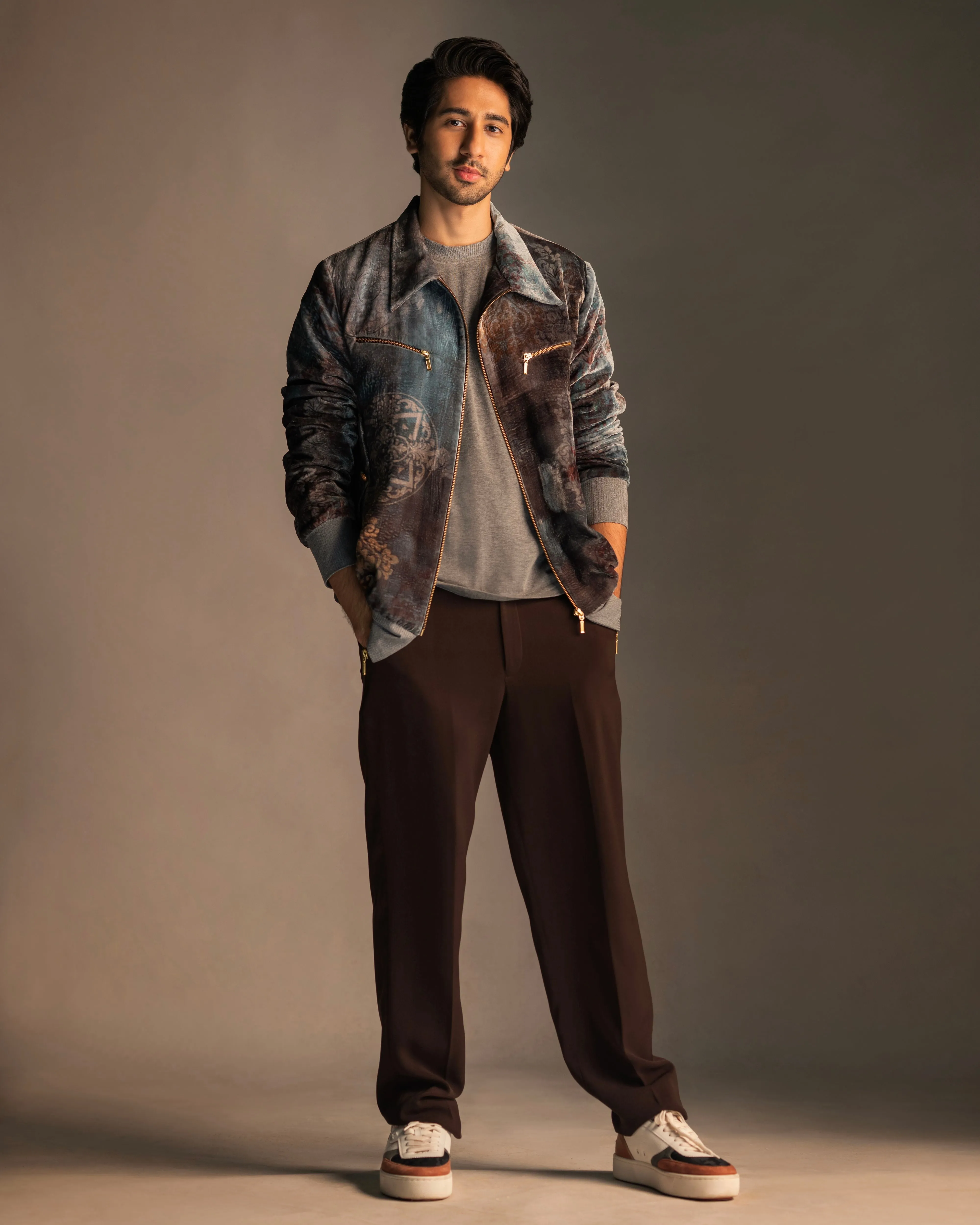 Vihaan Samant in Nirmooha's Printed Velvet Bomber Jacket with Grey T-Shirt and Brown Pants from Ancienne Collection