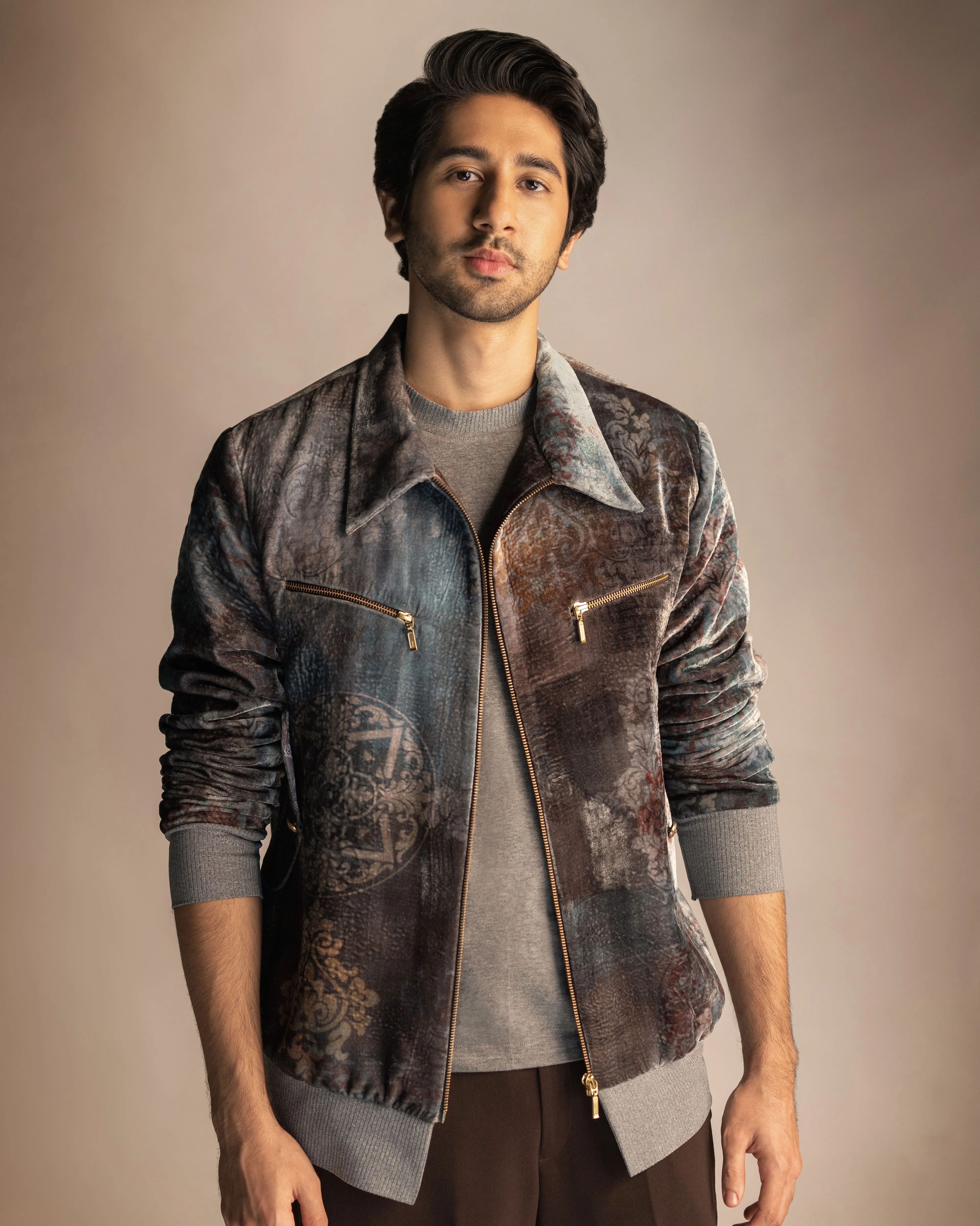 Vihaan Samant in Nirmooha's Printed Velvet Bomber Jacket with Grey T-Shirt and Brown Pants from Ancienne Collection