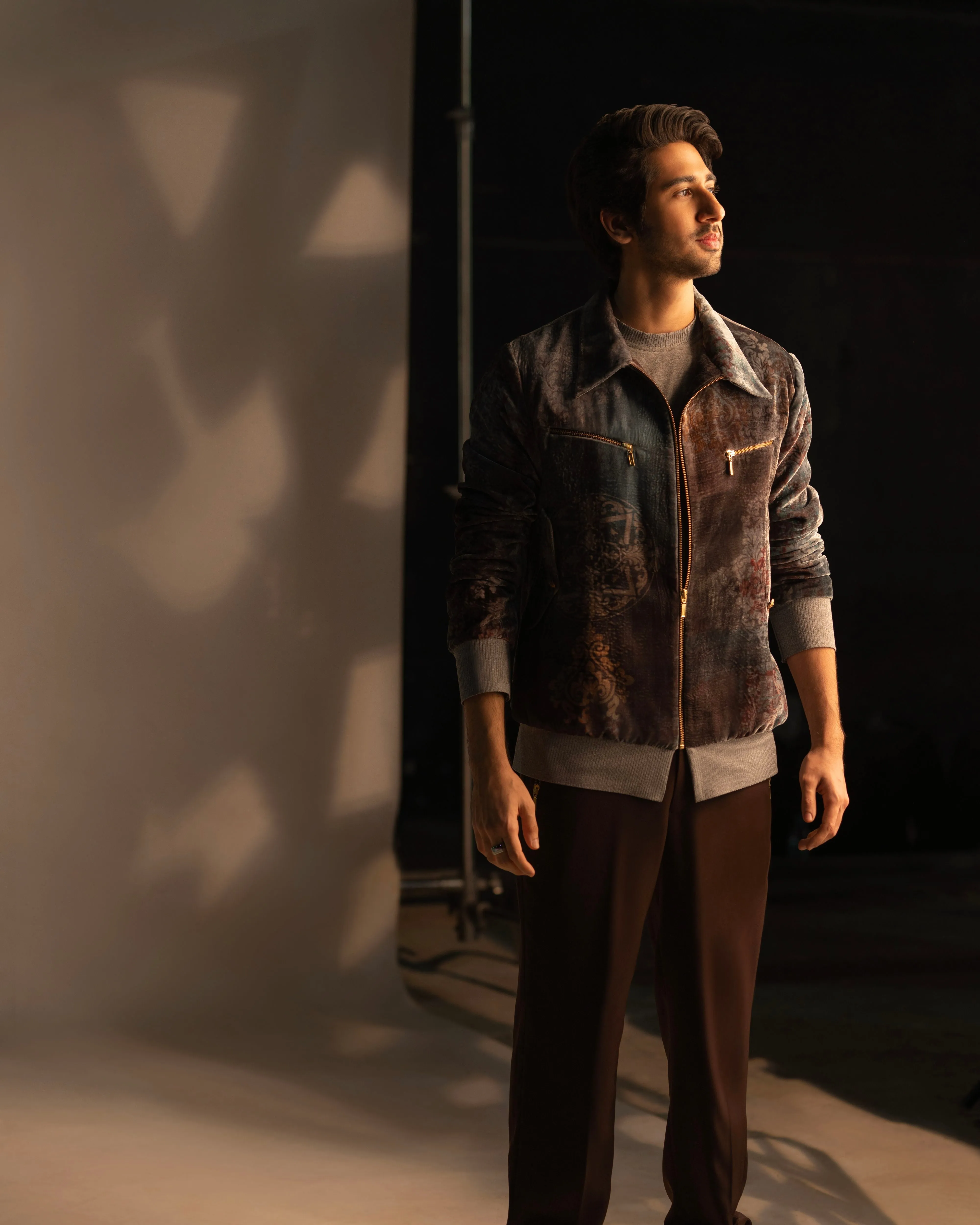 Vihaan Samant in Nirmooha's Printed Velvet Bomber Jacket with Grey T-Shirt and Brown Pants from Ancienne Collection