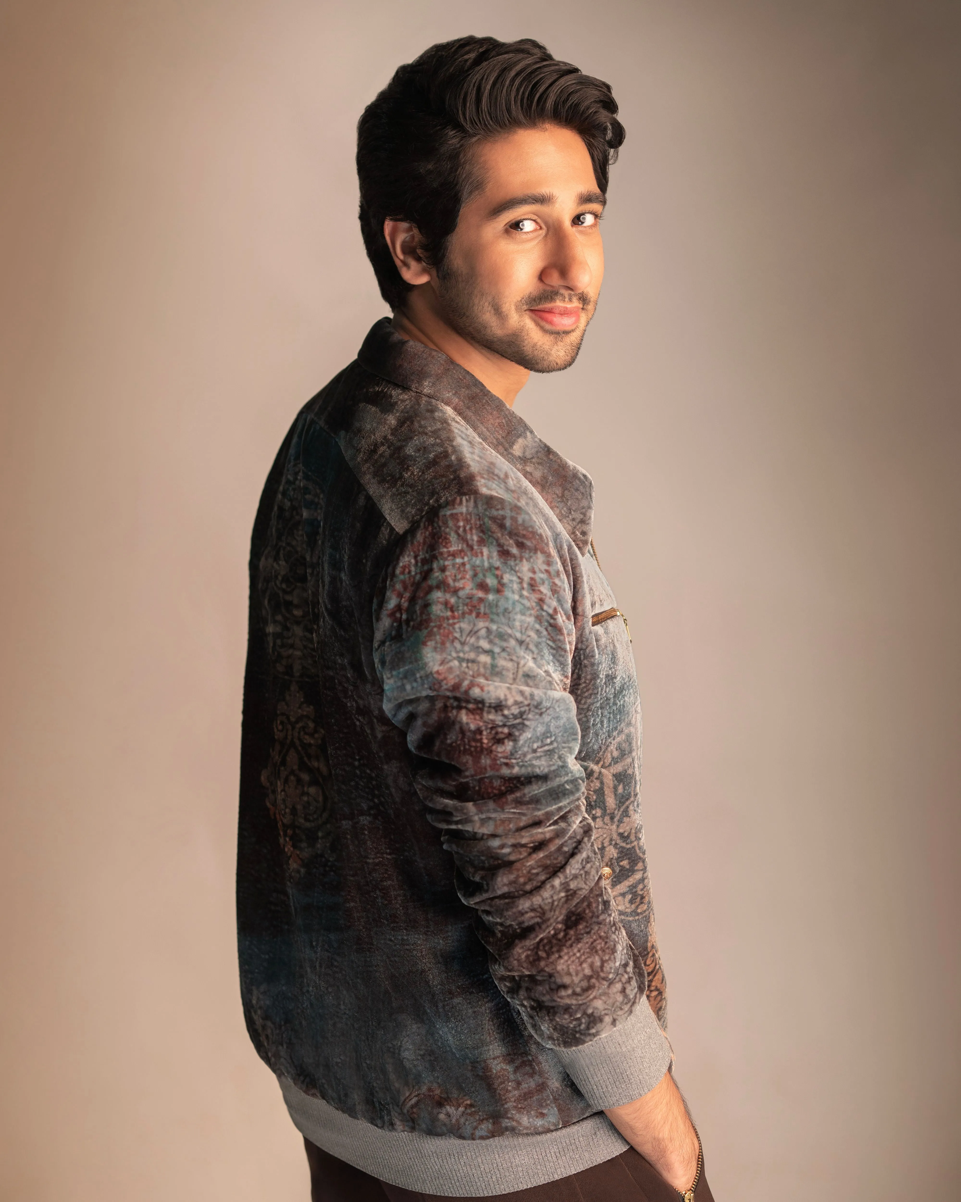 Vihaan Samant in Nirmooha's Printed Velvet Bomber Jacket with Grey T-Shirt and Brown Pants from Ancienne Collection